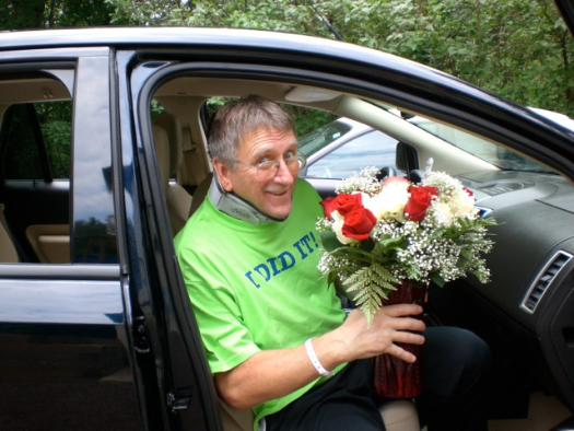 man, home from hospital with flowers