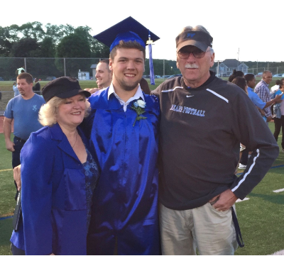 grandson and grandparents on graduation day blue robe