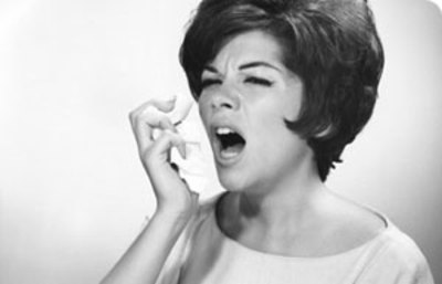 black and white photo of woman sneezing